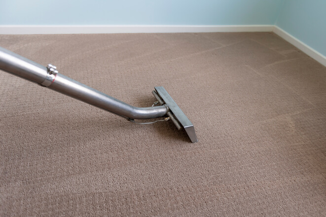 Picture showing a residential carpet being vacuumed