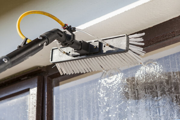 a picture showing a brush with a water-fed pole. This is typically a fast, cheaper and more efficient way to clean windows, especially for residential cleaning