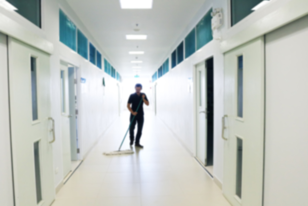 Janitor mopping a floor in a commercial space